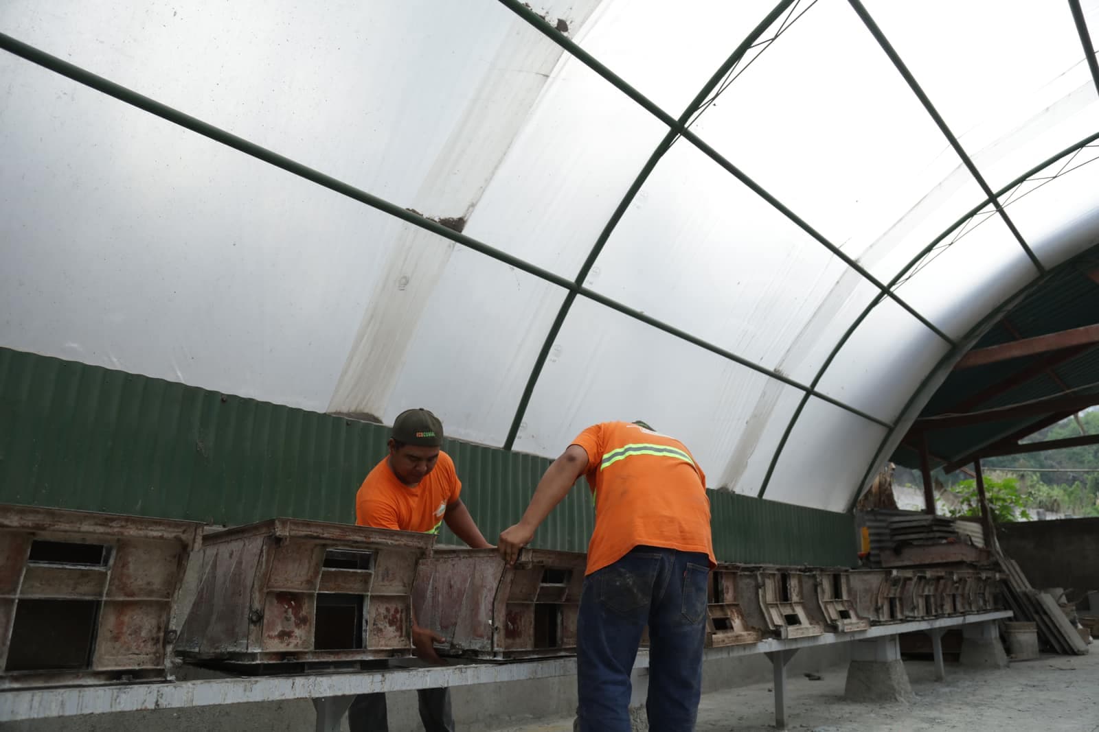 Operarios de Ecocomal desmoldando cuerpos de estufa en la línea de producción